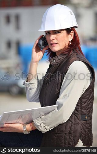 Female site manager using radio to communicate