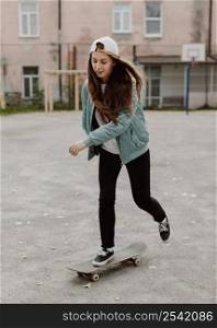 female skater practicing skateboarding outdoors