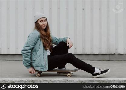 female skater sitting her skateboarding outdoors 4