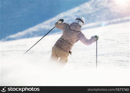 Female skier skiing down the slope