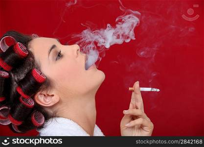Female smoker exhaling puffs of smoke
