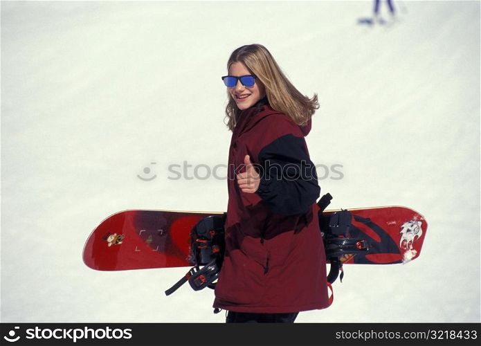 Female Snowboarder Giving Thumbs Up