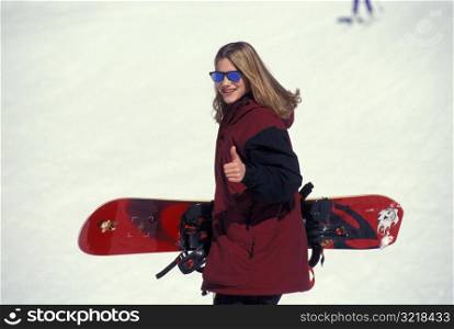 Female Snowboarder Giving Thumbs Up