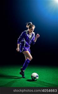 Female soccer player running with ball