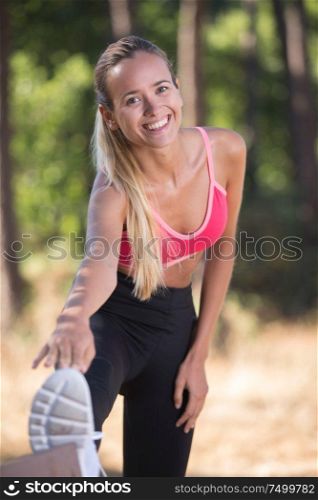 female stretching legs after workout