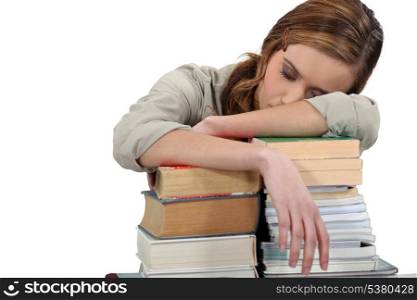 Female student asleep on her books