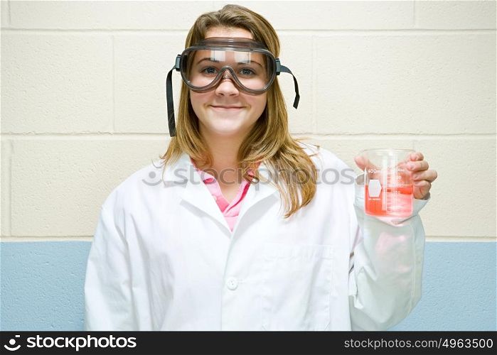 Female student holding flask of chemicals