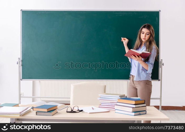 Female student in front of chalkboard. Female student in front of chalkboard 