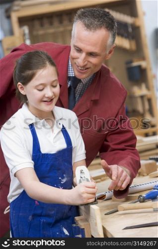 Female student learning woodworking