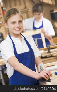 Female student learning woodworking