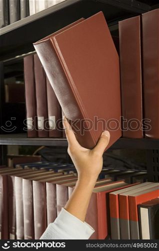 Female student reaching for a book