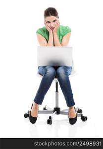 Female student sitting on a chair with a laptop and upset with something, isolated over a white background