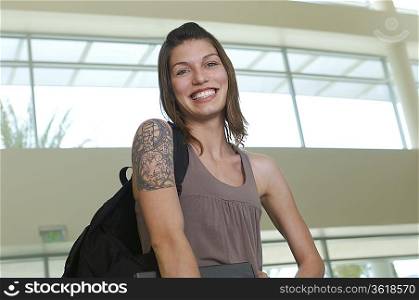 Female student smiling, indoors, portrait