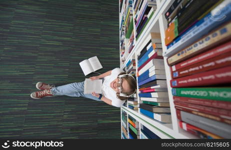 female student study in library using tablet and searching internet while Listening music and lessons on white headphones