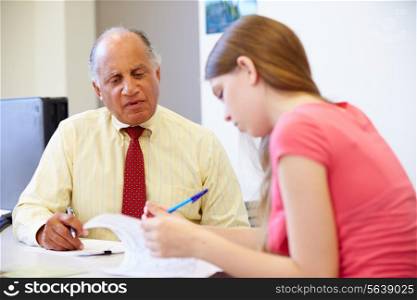 Female Student Talking To High School Counselor