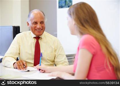 Female Student Talking To High School Counselor
