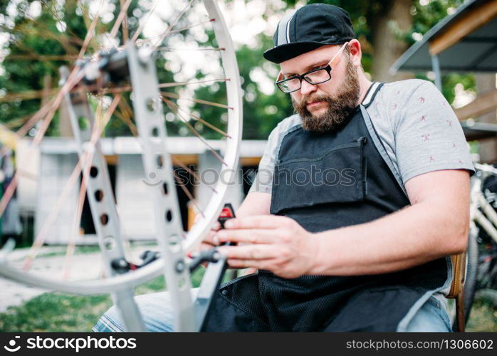 Female student with laptop sitting on the bench in summer park, top view. Ginger teenager leisures outdoors, pretty girl relax outside