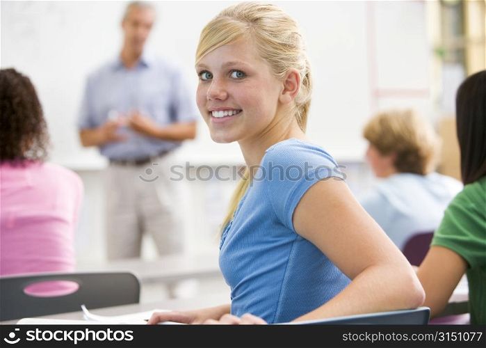 Female student with other students in classroom