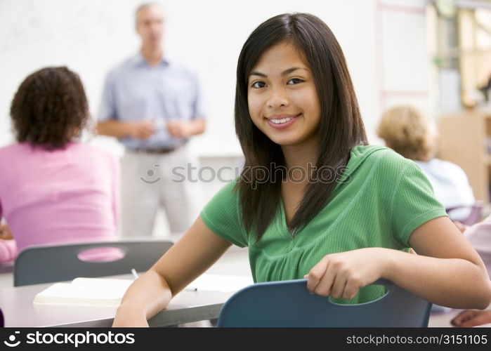 Female student with other students in classroom