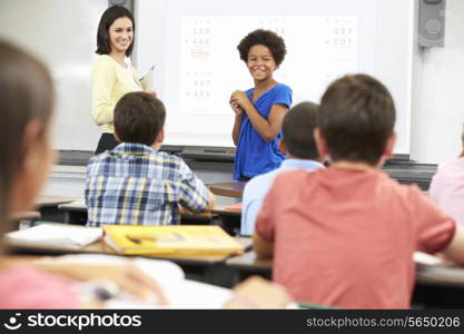 Female Student Writing Answer On Whiteboard