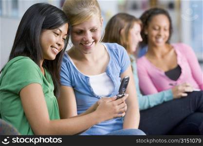 Female students looking at a mobile phone
