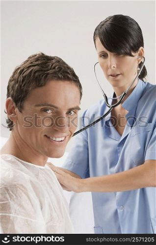 Female surgeon examining a mid adult man