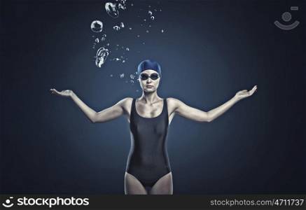 Female swimmer. Portrait of woman swimmer in cap and glasses