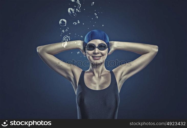 Female swimmer. Portrait of woman swimmer in cap and glasses