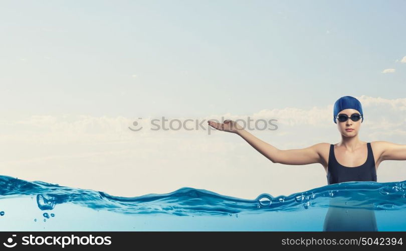 Female swimmer. Portrait of woman swimmer in cap and glasses