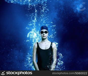 Female swimmer. Portrait of woman swimmer in cap and glasses