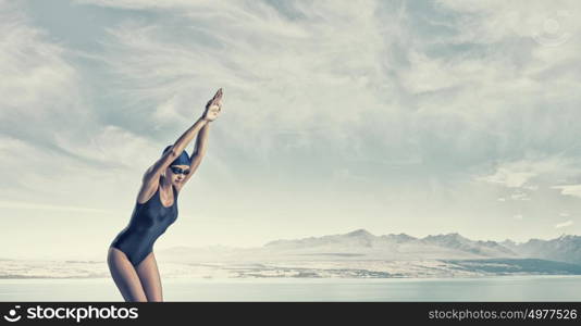 Female swimmer. Young woman competition swimmer in starting pose