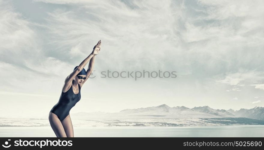 Female swimmer. Young woman competition swimmer in starting pose