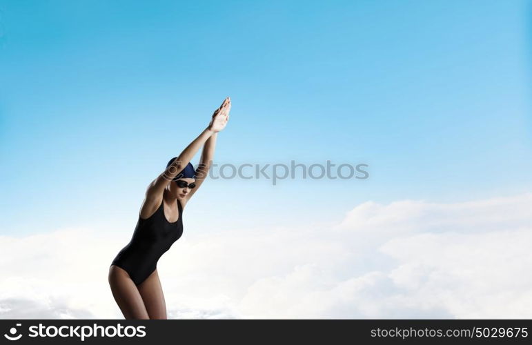 Female swimmer. Young woman competition swimmer in starting pose