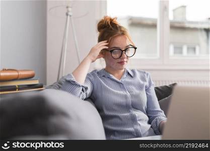 female teacher couch home holding online class