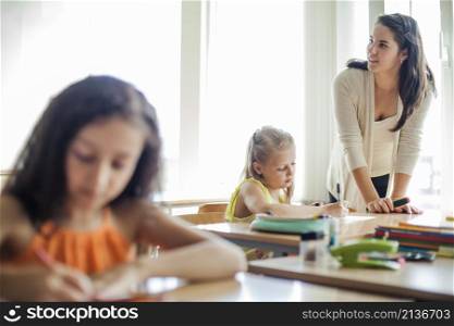 female teacher leaning upon table looking away