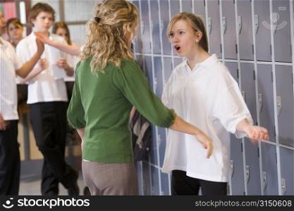 Female teacher reprimanding a female student