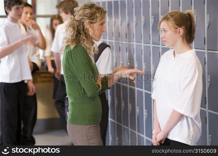Female teacher reprimanding a female student