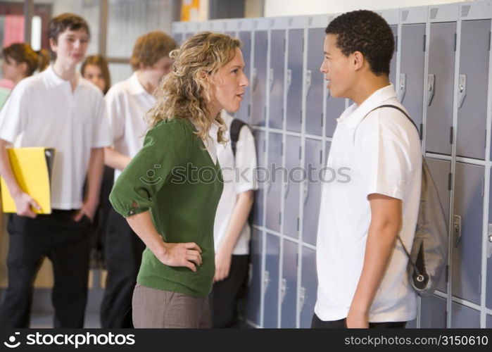 Female teacher reprimanding a male student