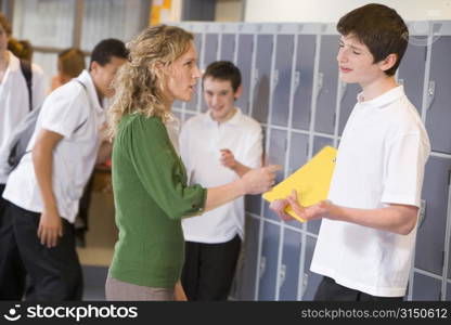 Female teacher reprimanding a male student