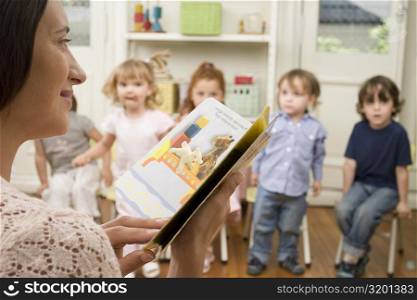 Female teacher teaching her students in a classroom