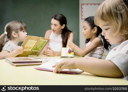 Female teacher teaching her students in a classroom