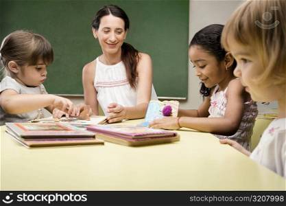 Female teacher teaching her students in a classroom