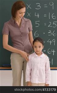 Female teacher with her student in a classroom