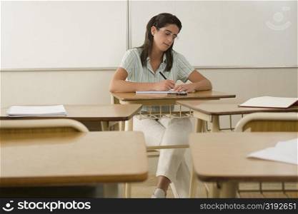 Female teacher writing in a classroom