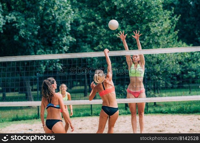 Female Team Playing Beach Volleyball