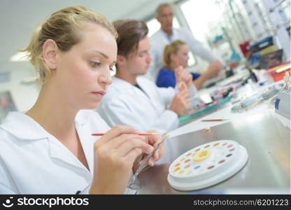 Female technician working in a dentures laboratory