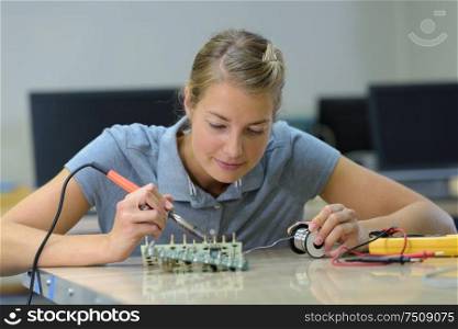 female technician working on machine part