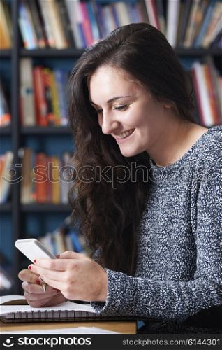 Female Teenage Pupil Texting In Classroom