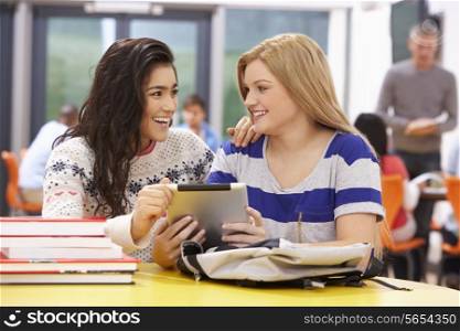 Female Teenage Students In Classroom With Digital Tablet