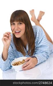Female teenager eat healthy whole wheat cereal for breakfast